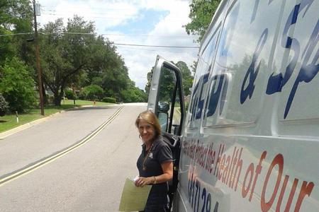 Kathlyn Smith, Owner of HEB Plumbing exits her van on the way to another job