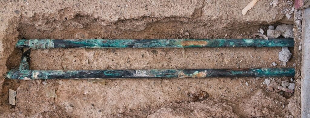 Rusty pipes in the concrete slab of a residential home.